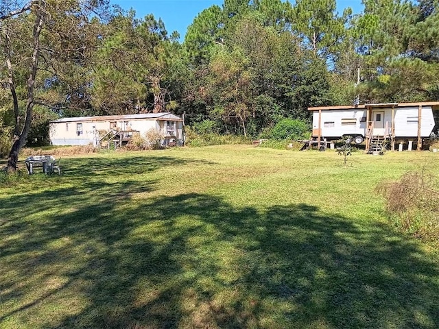 view of yard featuring a forest view