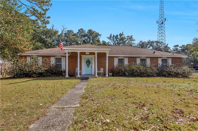 ranch-style home with a front lawn and brick siding