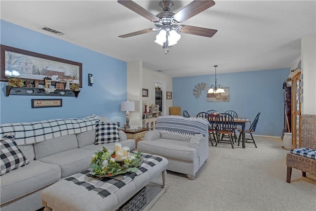 living area with light carpet, ceiling fan with notable chandelier, and visible vents