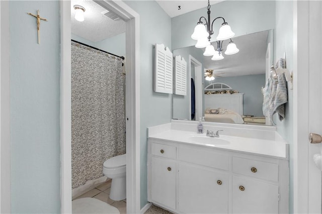 bathroom featuring toilet, ceiling fan with notable chandelier, vanity, tile patterned floors, and ensuite bath