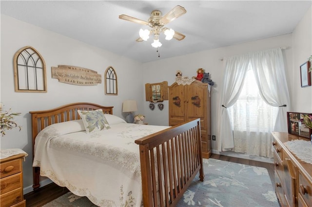 bedroom featuring a ceiling fan and dark wood finished floors