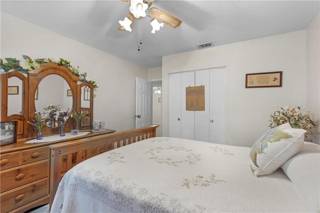 bedroom featuring a ceiling fan, a closet, and visible vents