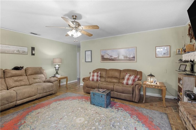 living room with ornamental molding, a ceiling fan, visible vents, and baseboards