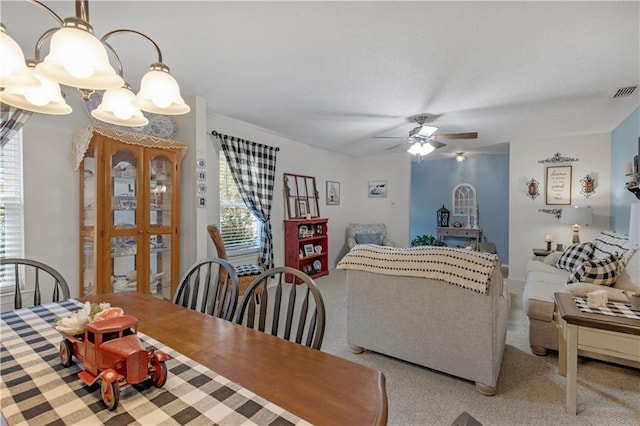 dining area with visible vents and ceiling fan with notable chandelier