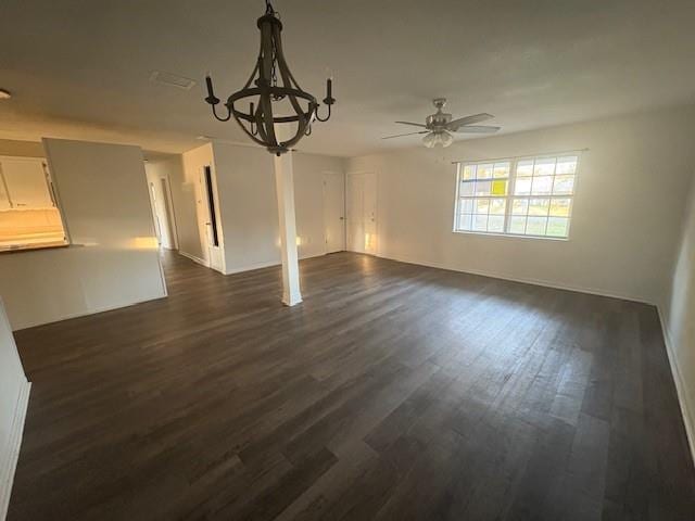 unfurnished dining area featuring dark wood-style floors and ceiling fan with notable chandelier