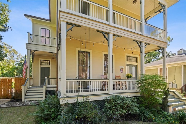 exterior space with covered porch and a balcony