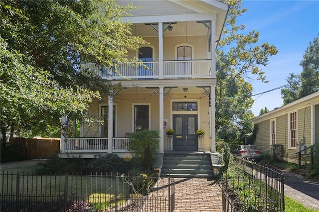 view of front of property featuring a porch and a balcony