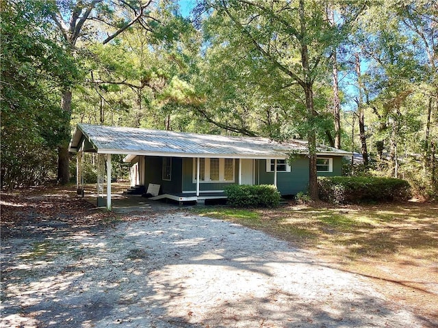 view of front facade with a porch and a carport