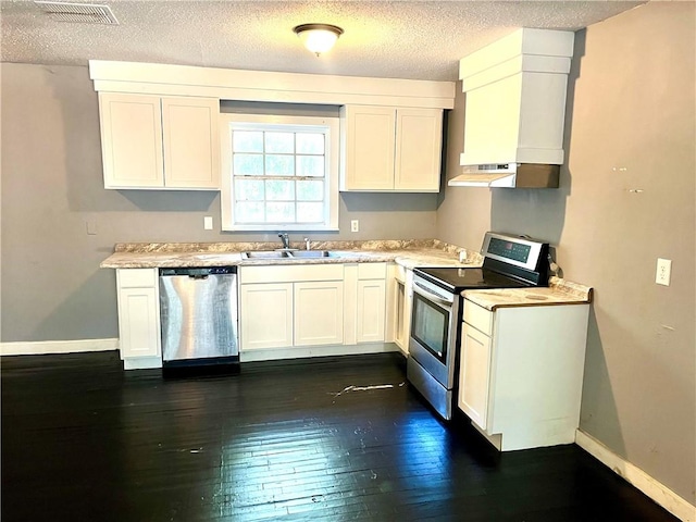 kitchen with sink, a textured ceiling, dark hardwood / wood-style flooring, white cabinetry, and stainless steel appliances