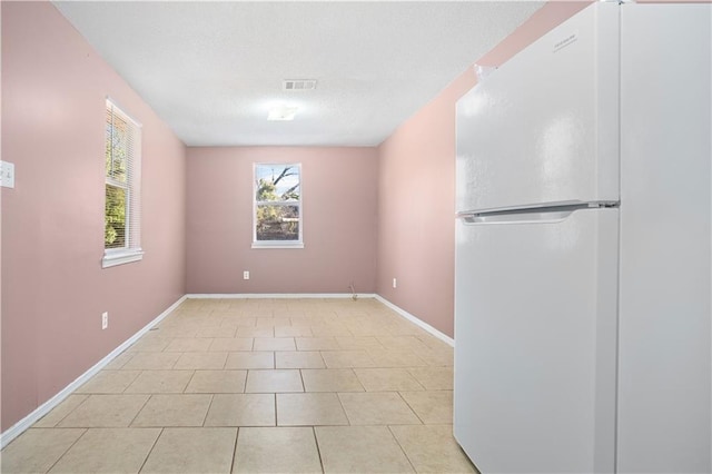 empty room with light tile patterned flooring