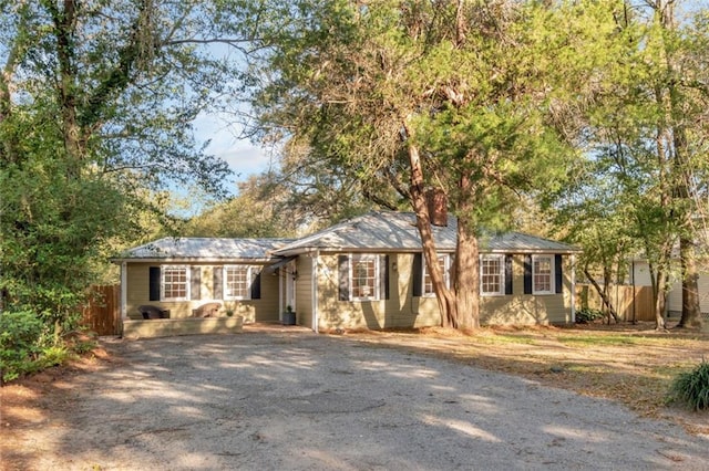 single story home featuring driveway and fence