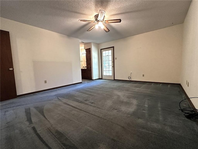 empty room with a ceiling fan, a textured ceiling, baseboards, and carpet