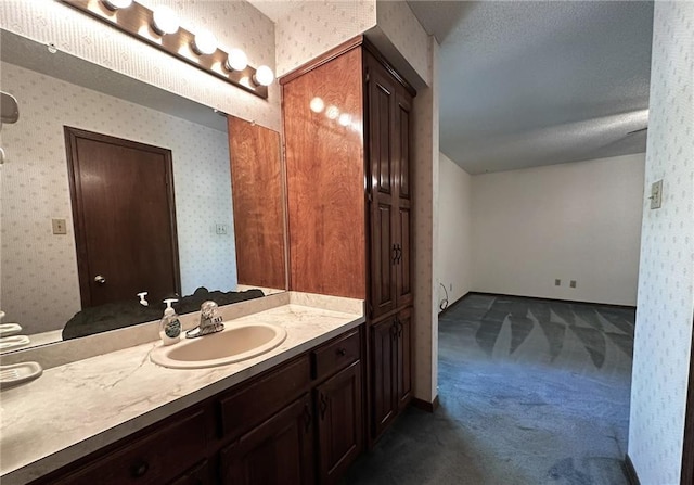 bathroom featuring a textured ceiling and vanity