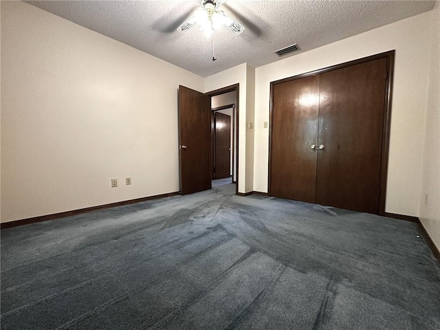 unfurnished bedroom with baseboards, carpet floors, visible vents, and a textured ceiling