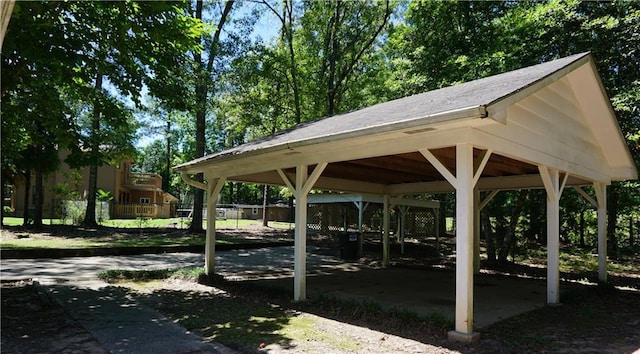 surrounding community featuring fence and a carport