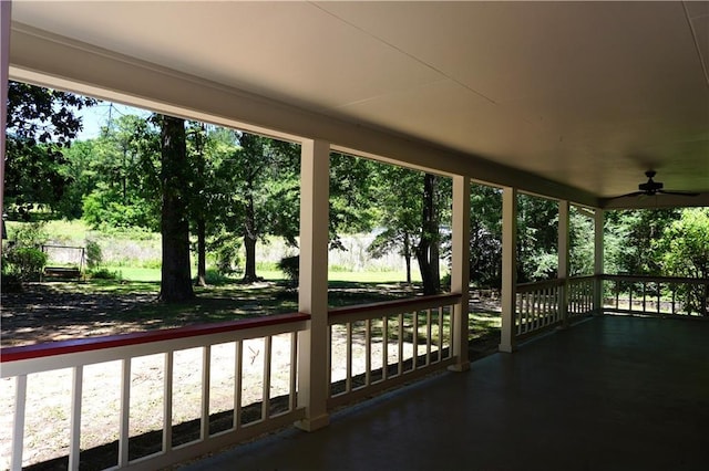 unfurnished sunroom featuring a ceiling fan
