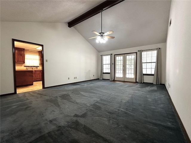 unfurnished living room with beam ceiling, a textured ceiling, ceiling fan, carpet flooring, and baseboards