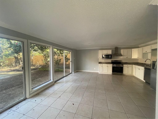 kitchen featuring white cabinets, stainless steel appliances, wall chimney exhaust hood, and light tile patterned flooring