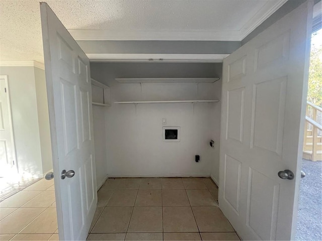 clothes washing area featuring hookup for a washing machine, tile patterned floors, hookup for an electric dryer, and a textured ceiling