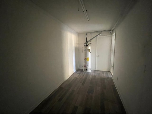 hallway featuring dark wood-type flooring and water heater