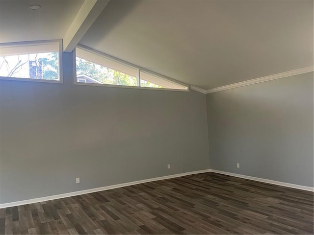 unfurnished room featuring dark wood-type flooring and lofted ceiling with beams