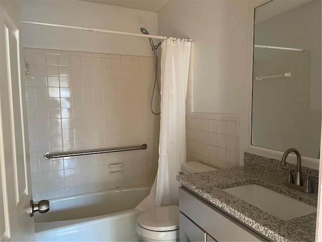 full bathroom with vanity, shower / tub combo, and toilet