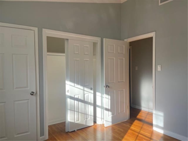 unfurnished bedroom with a closet and light hardwood / wood-style flooring