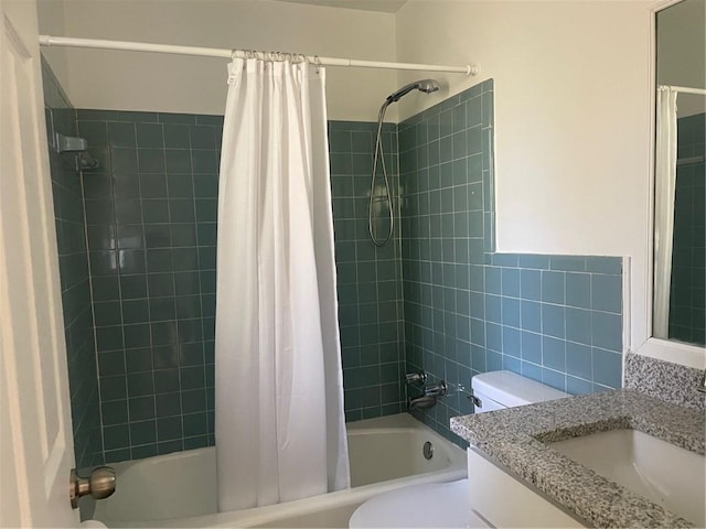 full bathroom featuring shower / bath combo, vanity, and toilet