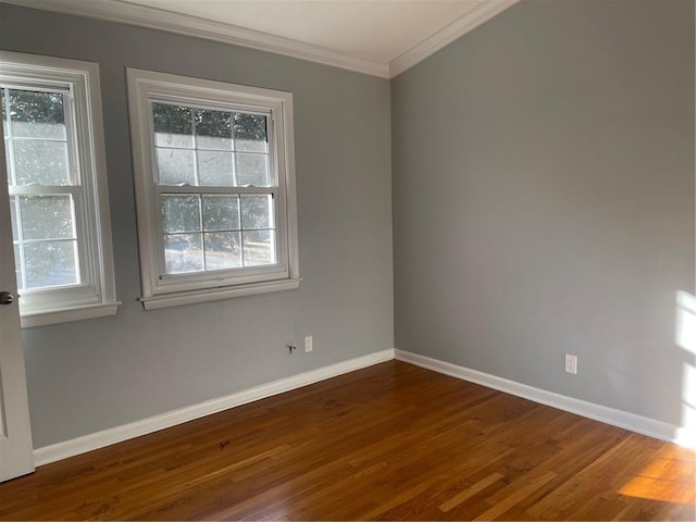 empty room featuring crown molding and dark hardwood / wood-style flooring