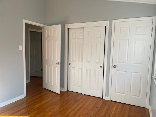 unfurnished bedroom featuring hardwood / wood-style floors and a closet