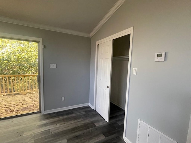 unfurnished bedroom with crown molding, dark hardwood / wood-style floors, and a closet