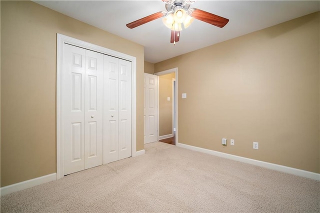 unfurnished bedroom featuring a closet, ceiling fan, baseboards, and carpet