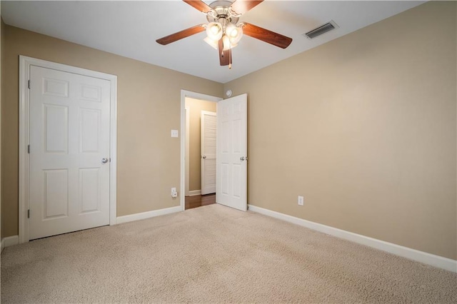 unfurnished bedroom with visible vents, baseboards, carpet, and a ceiling fan