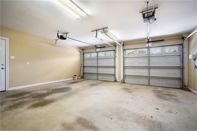 garage with a garage door opener and baseboards