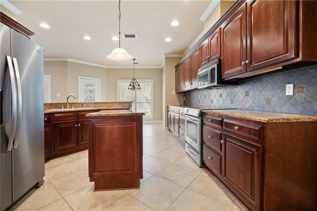 kitchen with tasteful backsplash, visible vents, crown molding, stainless steel appliances, and a sink