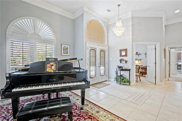 miscellaneous room with light tile patterned floors, crown molding, and french doors