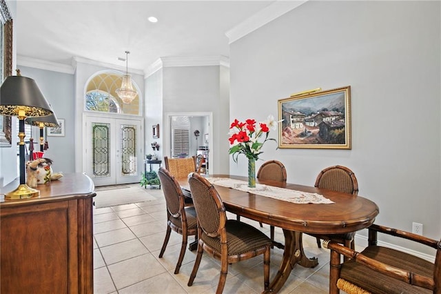 dining area with french doors, light tile patterned flooring, and ornamental molding