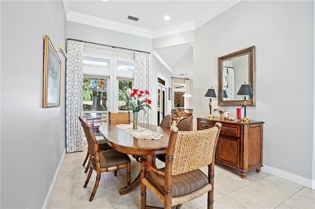 tiled dining area featuring ornamental molding