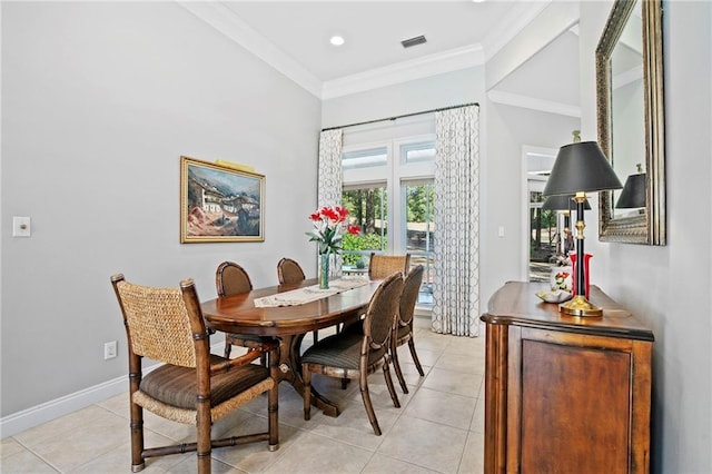 dining room with crown molding and light tile patterned flooring