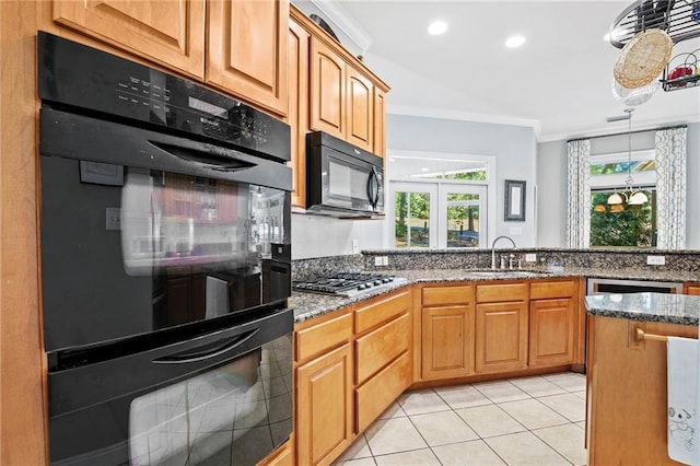 kitchen with dark stone countertops, black appliances, sink, crown molding, and light tile patterned floors