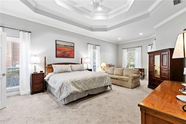 carpeted bedroom with ceiling fan, ornamental molding, and a raised ceiling