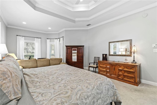 carpeted bedroom with ornamental molding and a tray ceiling