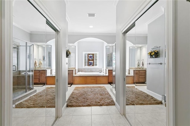 bathroom featuring plus walk in shower, vanity, crown molding, and tile patterned flooring