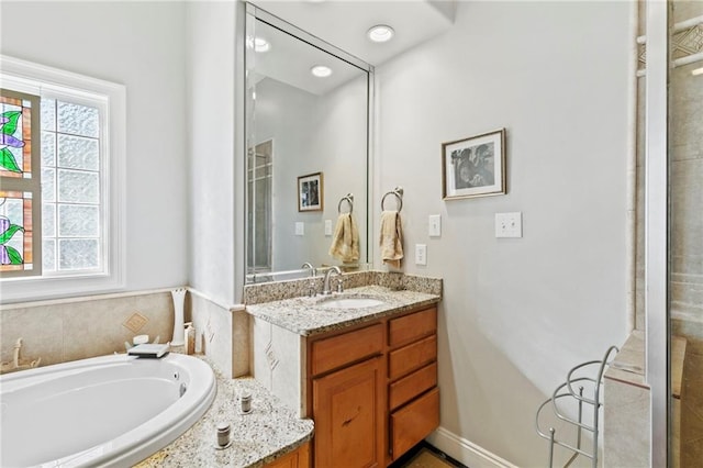 bathroom featuring independent shower and bath and vanity