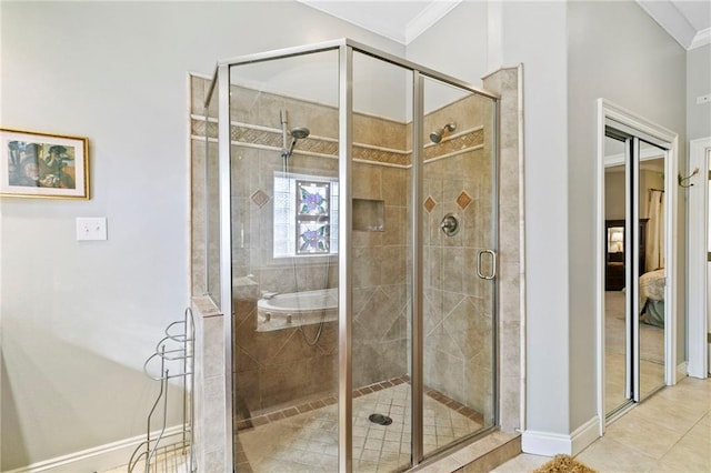 bathroom with tile patterned floors, a shower with door, and ornamental molding