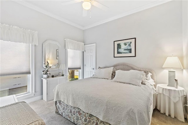 bedroom featuring ceiling fan, light carpet, crown molding, and multiple windows