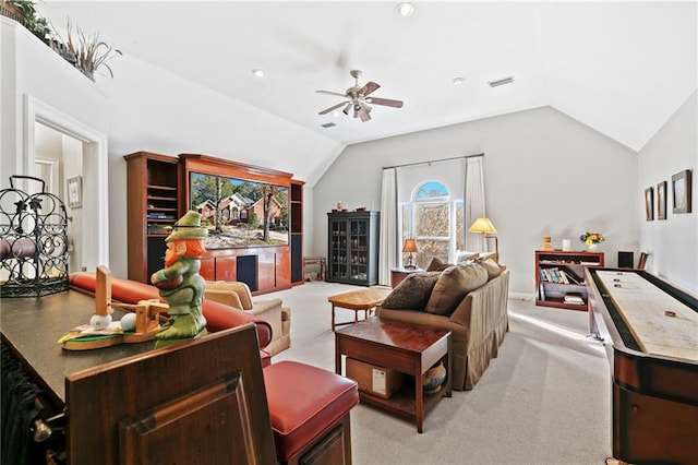 living room with ceiling fan, lofted ceiling, and light colored carpet