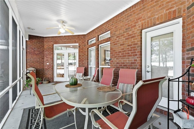 sunroom with ceiling fan and french doors