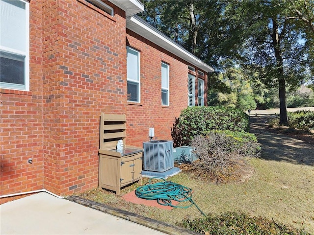 view of side of home featuring a patio and central air condition unit