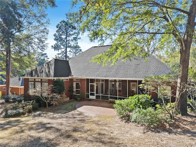 back of property with a patio area and a sunroom